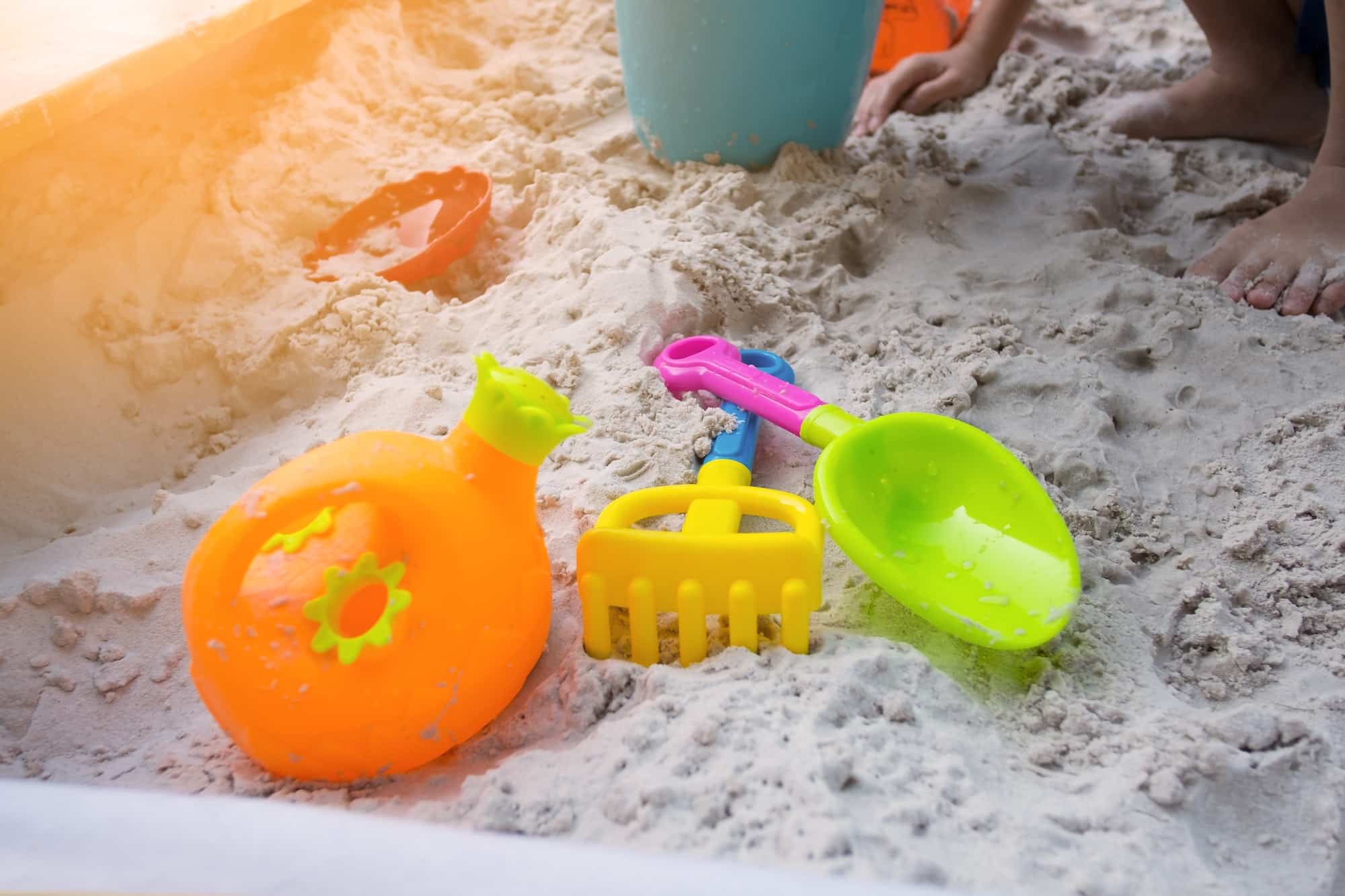 Sandbox kid playground with colourful toys to play on the beach